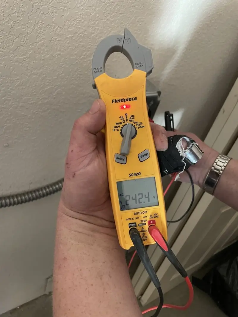 Voltage testing with clamp meter during Recessed Lighting Installation in Calabash